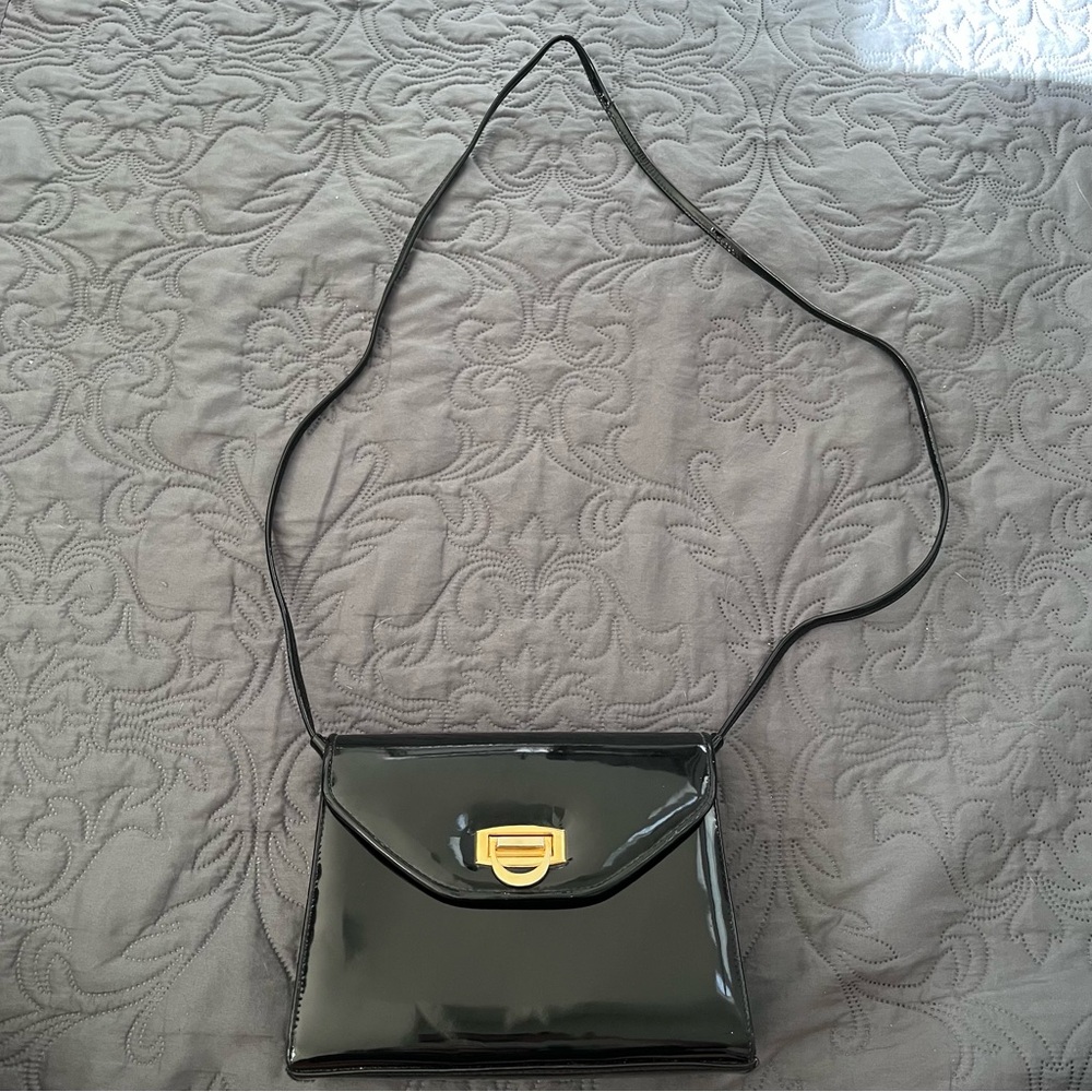 Bechamel Black Shoulder Bag with Gold Hardware and Interchangeable Handles.